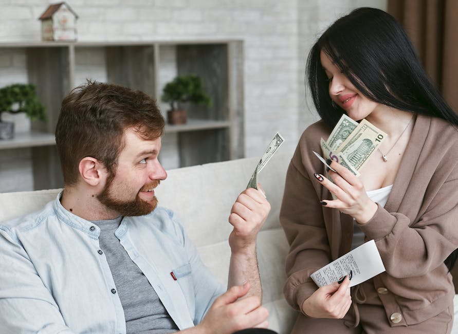 A cheerful couple managing their finances at home, holding cash and a receipt.