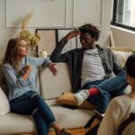 A couple is engaged in a lively conversation during a therapy session with a counselor.
